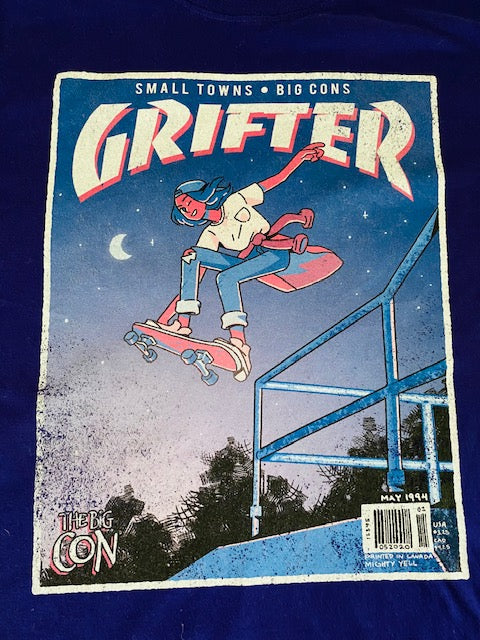 A t-shirt that says "GRIFTER," stylized like an old THRASHER magazine cover, featuring Ali from The Big Con jumping on a skateboard over some stairs. Deep purple shirt, with the image stylized like a magazine cover in rectangle on the front of the shirt. Magazine cover colours are largely Blue, light blue, and pink, like a stylized night sky. The magazine cover has a distressed look, like an old print.