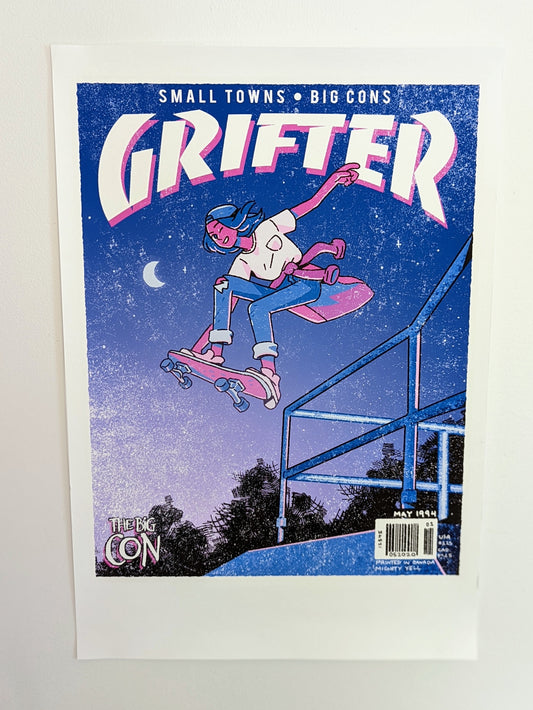 A poster that says "GRIFTER," stylized like an old THRASHER magazine cover, featuring Ali from The Big Con jumping on a skateboard over some stairs. Image stylized like a magazine cover in rectangle on the front of the shirt. Magazine cover colours are largely Blue, light blue, and pink, like a stylized night sky. The magazine cover has a distressed look, like an old print.